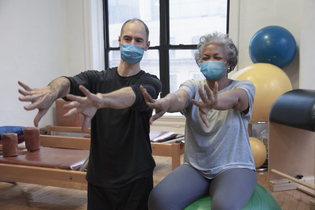 people doing exercise at rehab center wearing masks