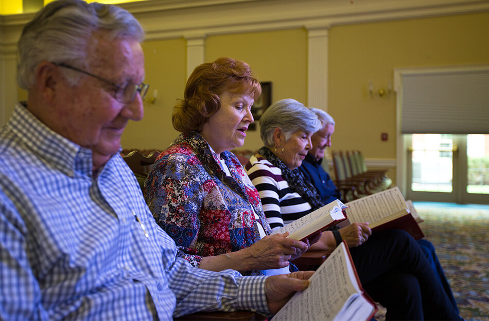 Group of seniors sitting and reading at church