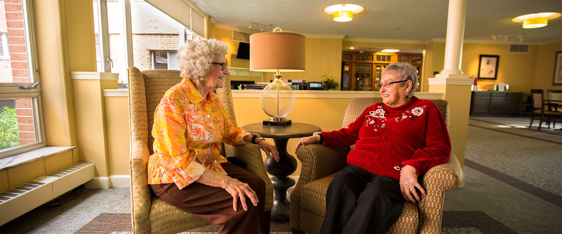 Senior friends sitting in the community room