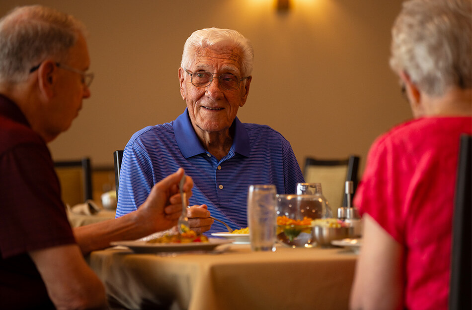 Seniors sitting around a table for dinner