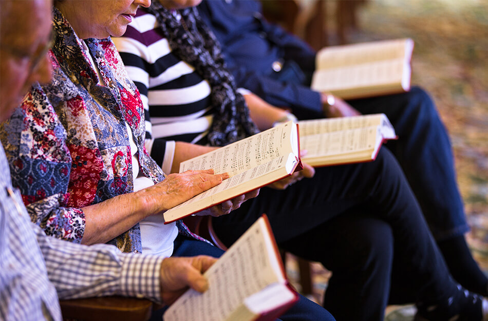 Group of seniors read hymns