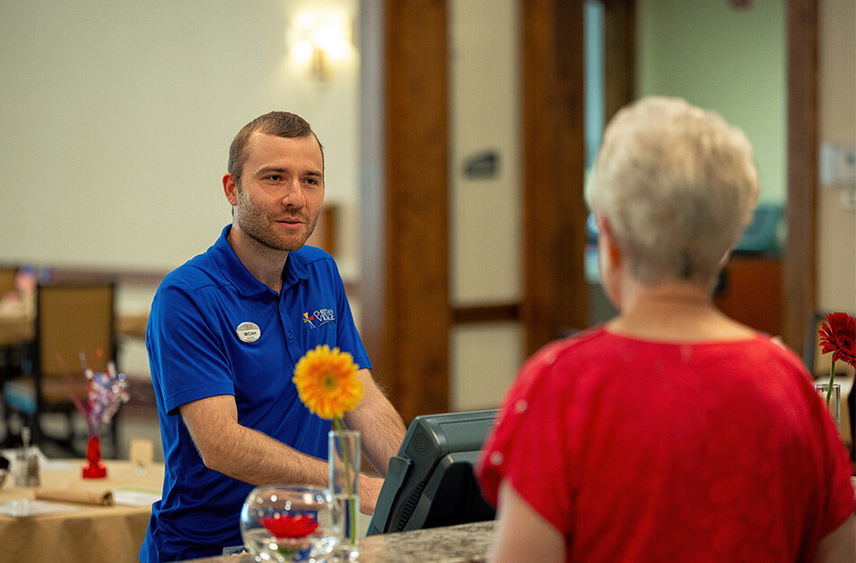 Senior woman talking to service worker