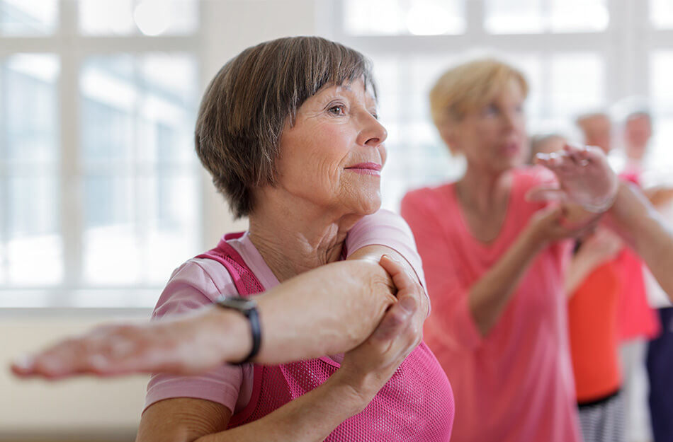 Retired woman stretches arm