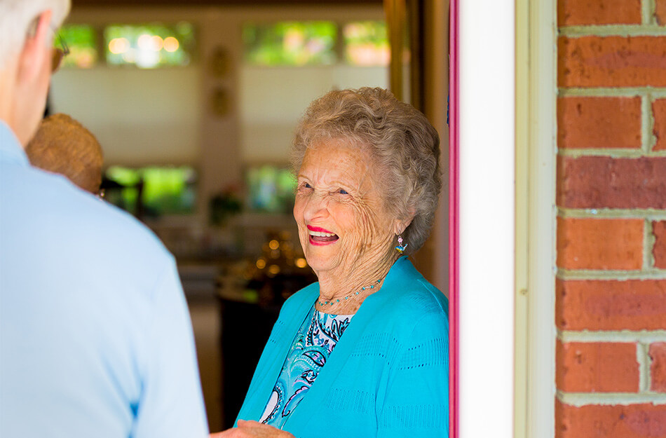 Senior talking to neighbor at doorstep