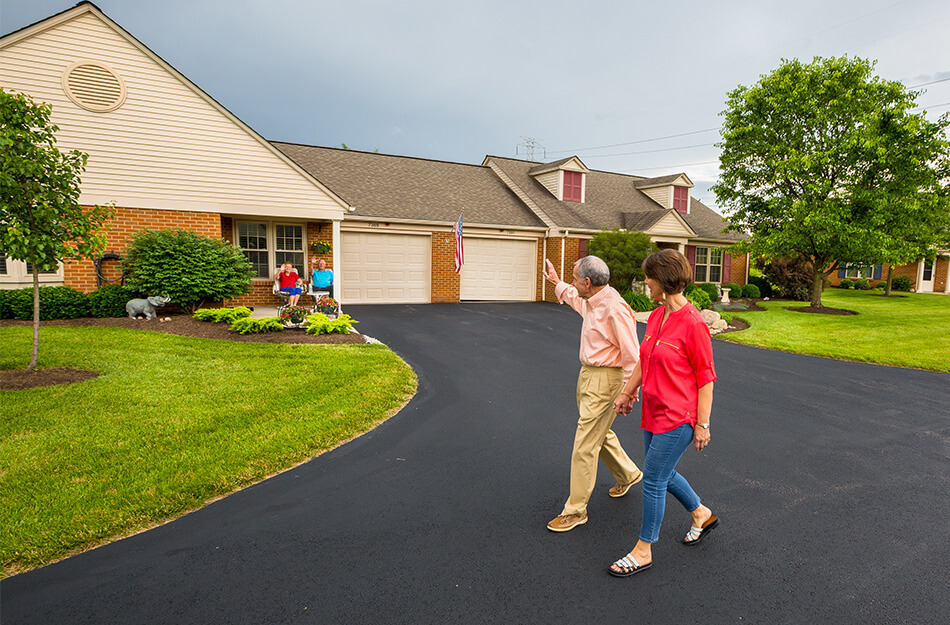 Neighbors wave as they walk past