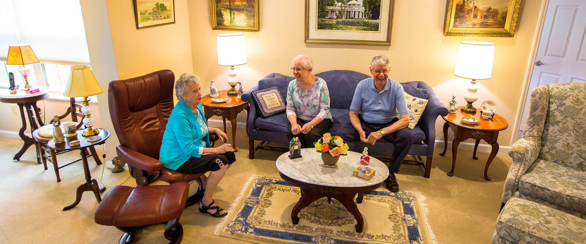 Seniors sitting in a living room together