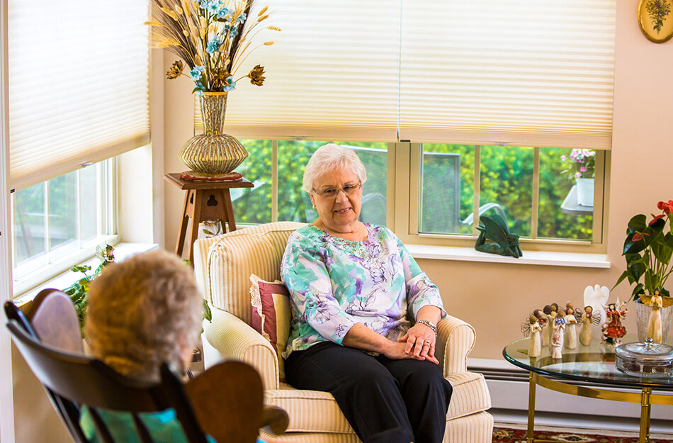 Friendly women sit in a room together chatting