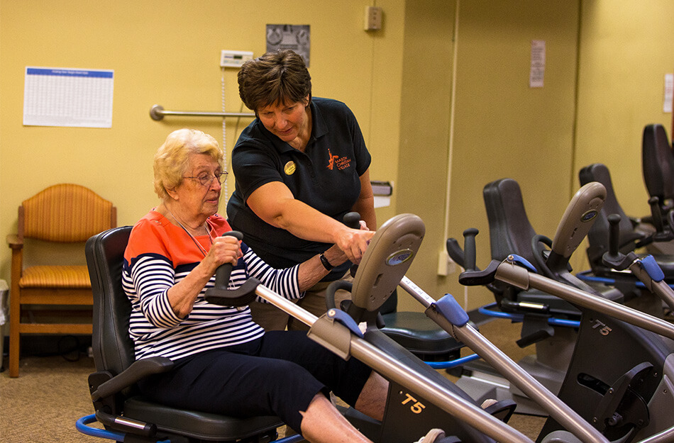 Senior woman doing physical therapy with trained professional