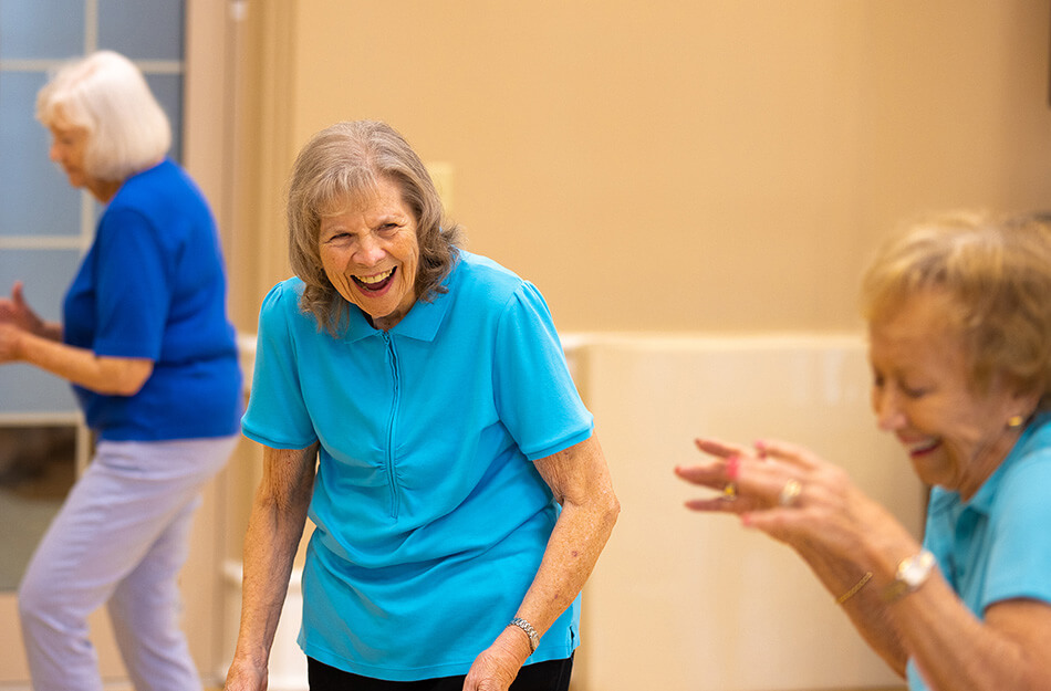Seniors laugh during exercise class