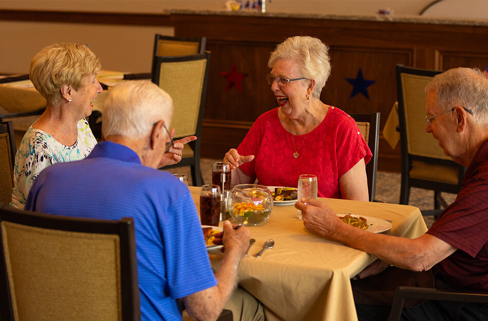 Seniors laugh at group dinner