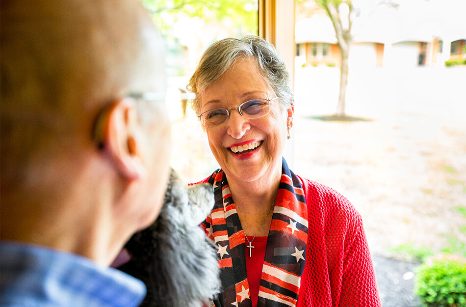 Senior friends chat with a dog