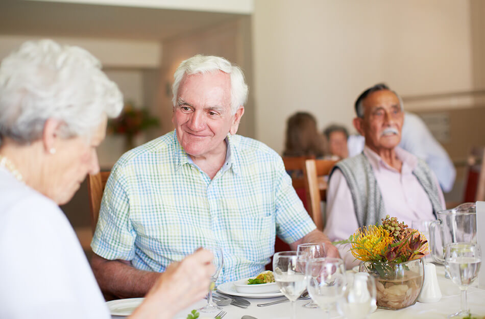 Senior man and woman eat dinner