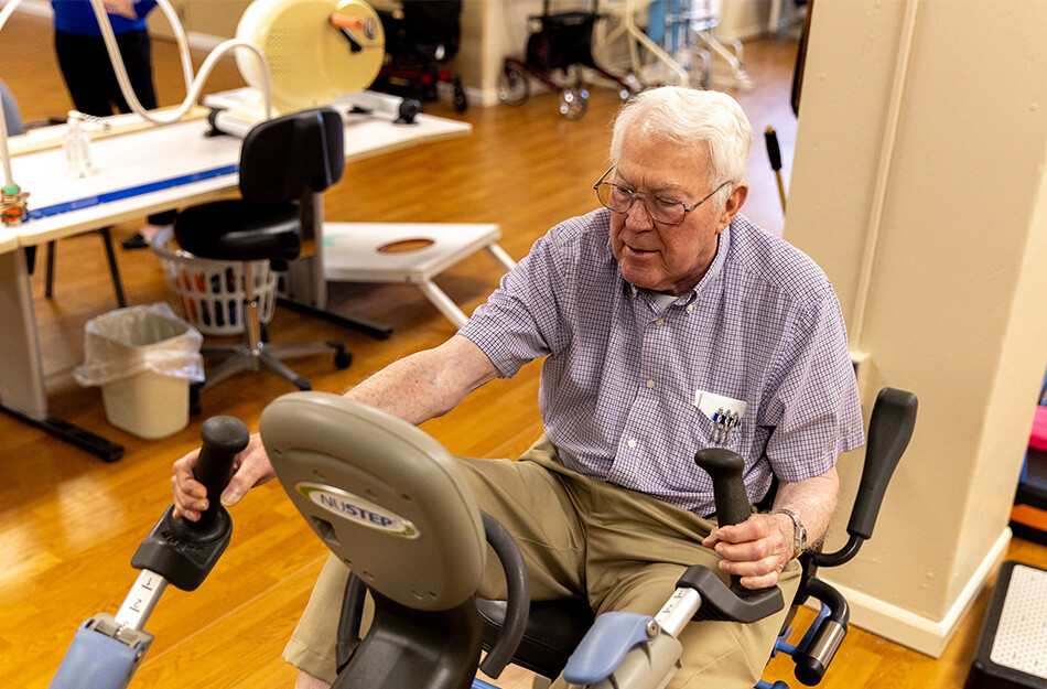 Senior man uses gym equipment to work out