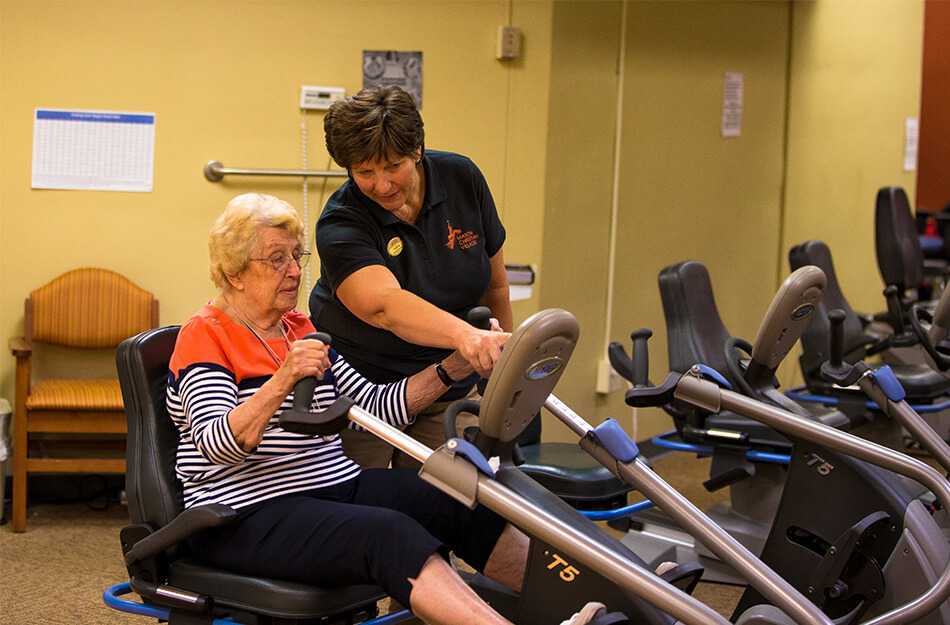 Elderly woman doing rehab with a professional