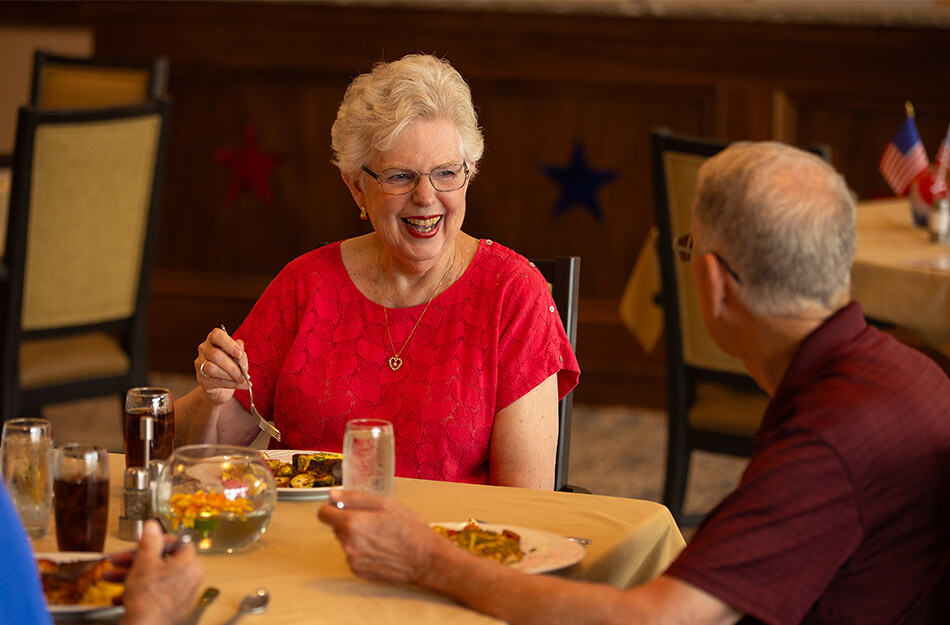 Senior friends enjoying a meal at dinner