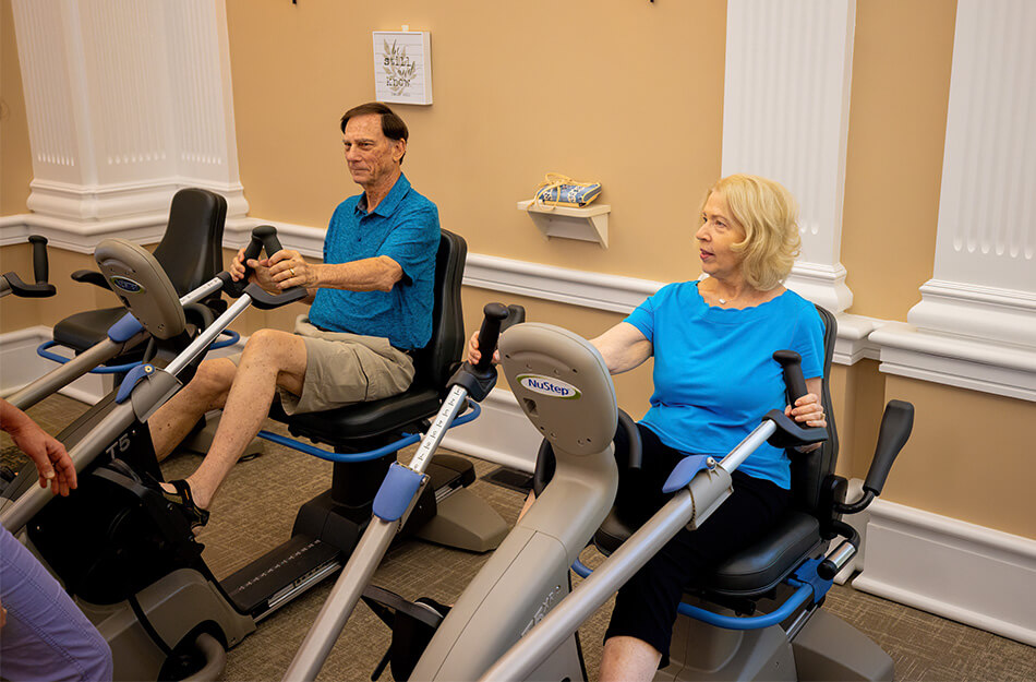 Seniors use machine in gym