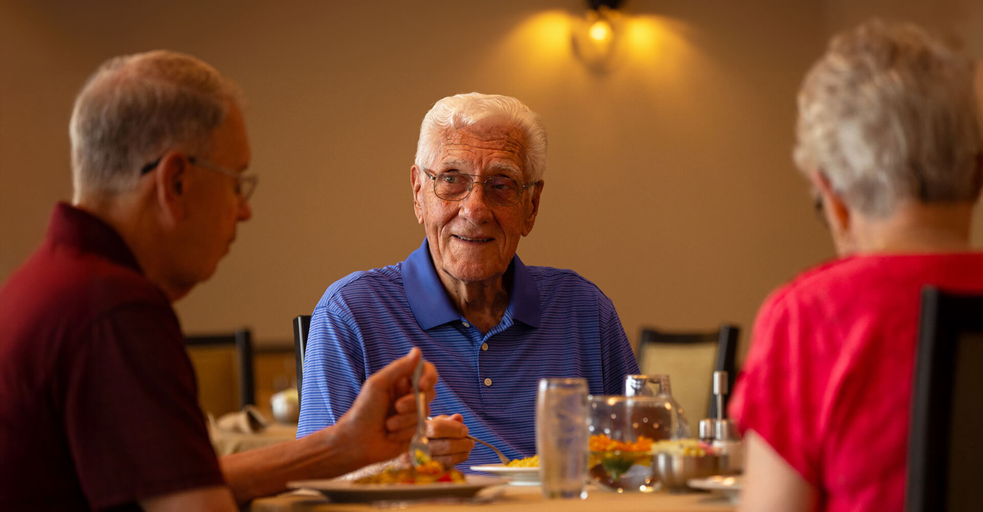 Senior friends eating together.