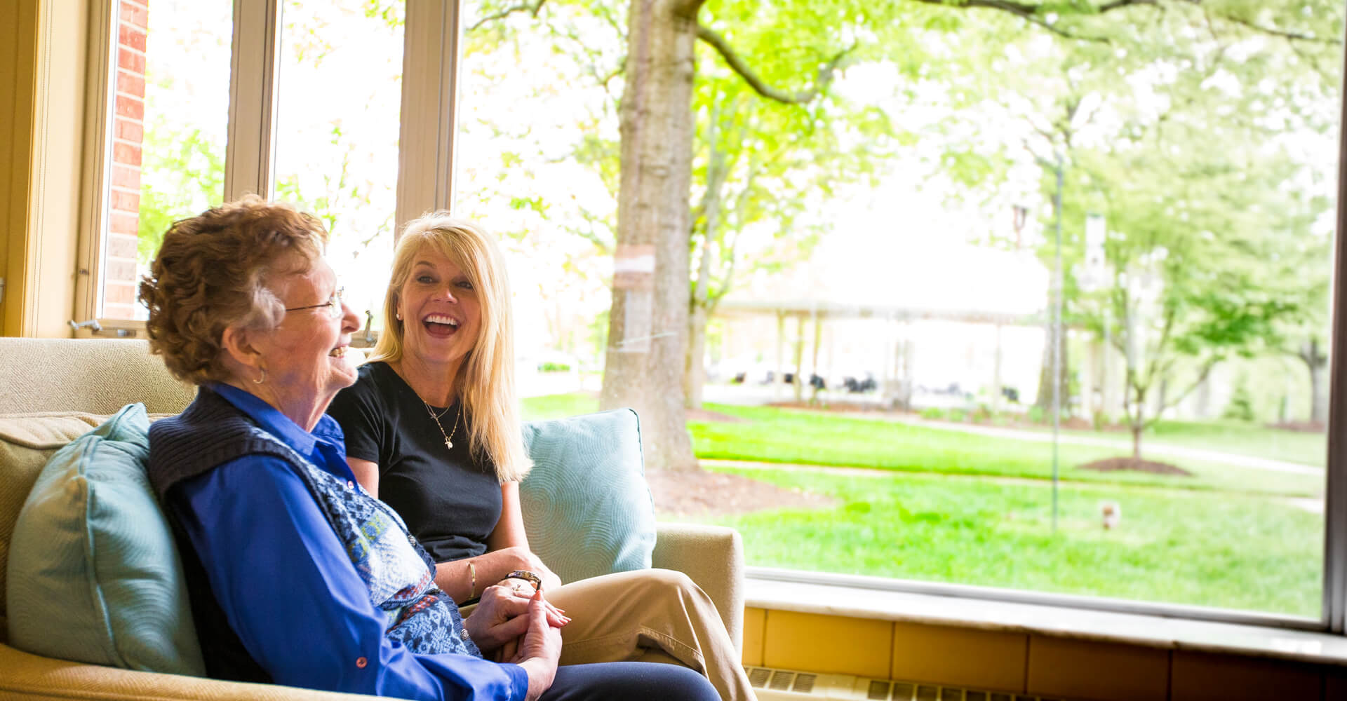 Senior with daughter laughing.