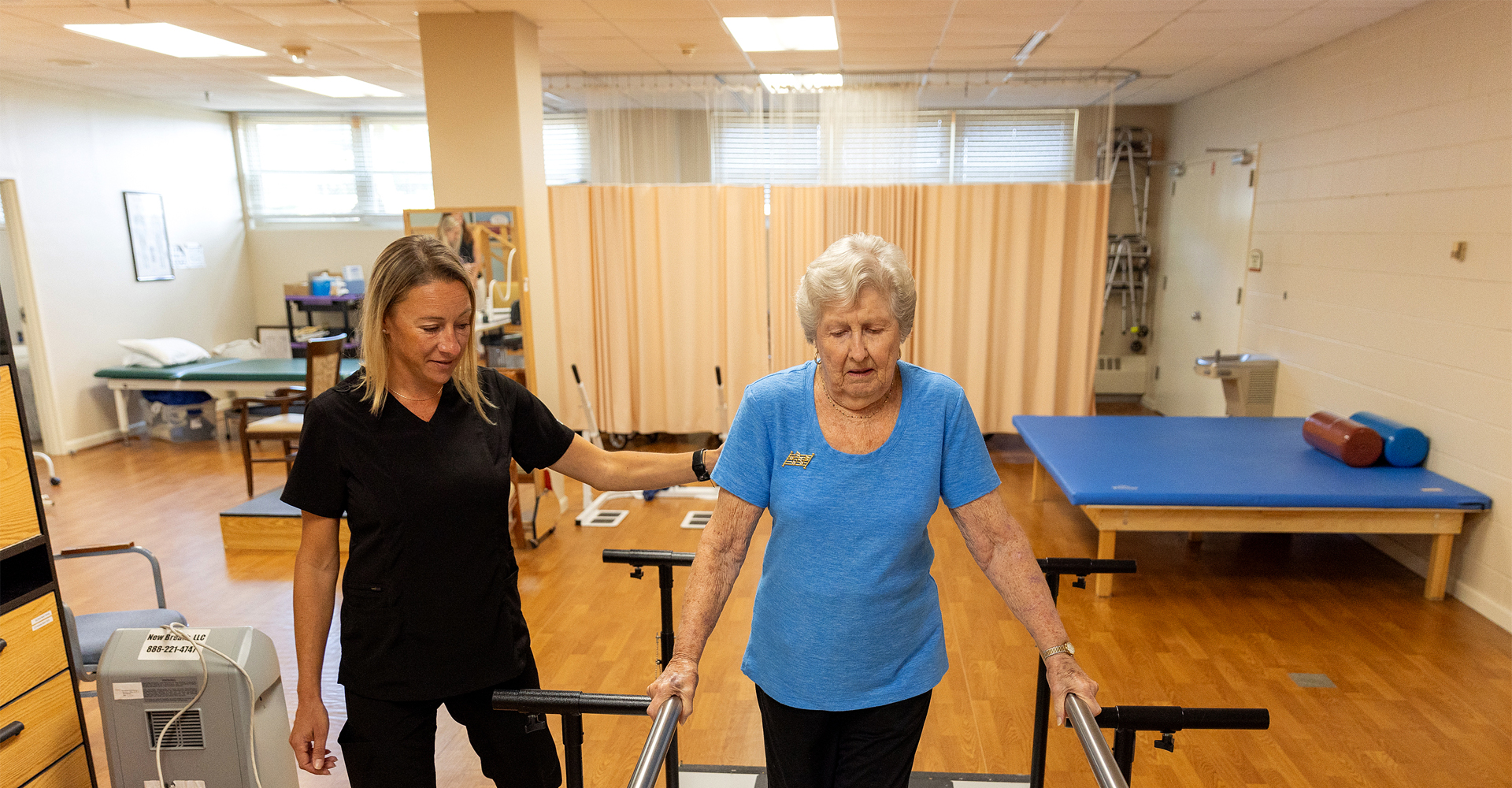 Senior woman walking rehabilitation with community caretaker.