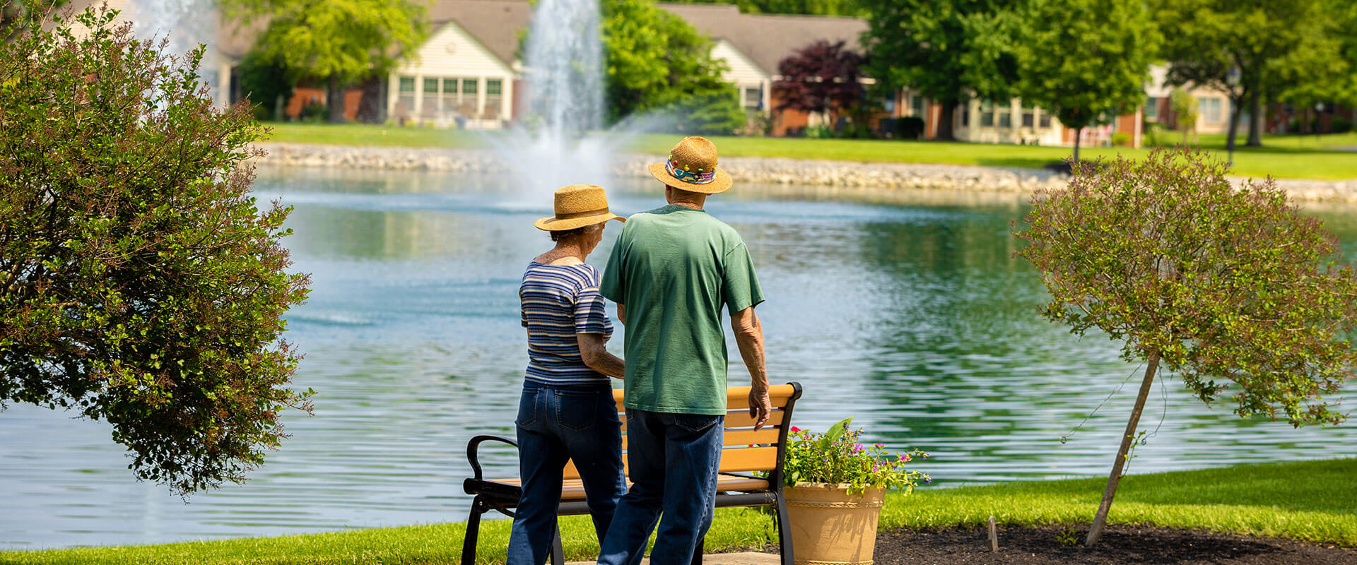 Senior couple walking around pond